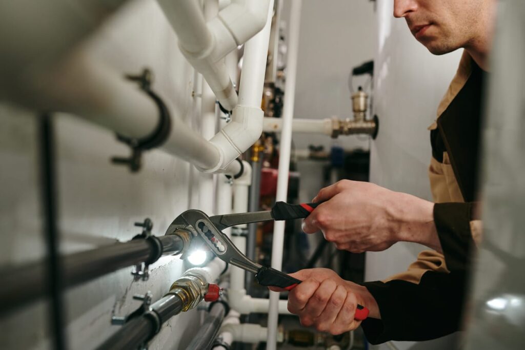 Plumbers maintaining commercial plumbing pipes in Bonita Springs