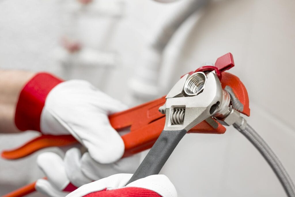 Plumber holding pipe wrenches for an emergency repair in Bonita Springs