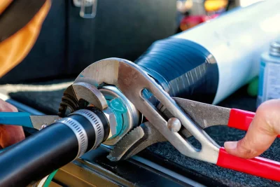 Technician tightening an industrial pipe connection in Bonita Springs